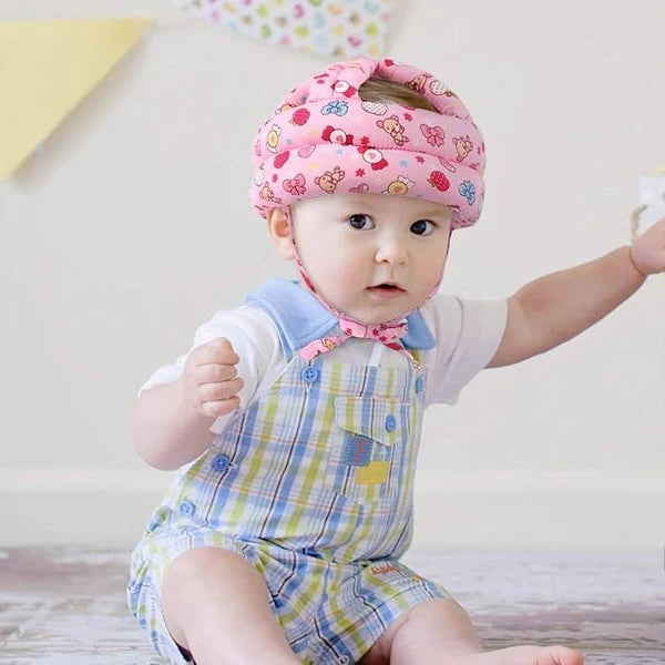 Baby wearing a soft protective safety helmet
